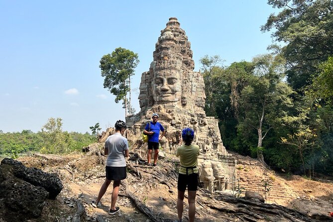Angkor Sunrise Bike Tour with Lunch Included - Riding the inner circuit: Victory Gate at Angkor Thom and Bayon faces