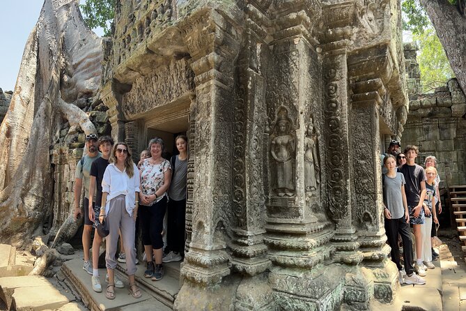 Angkor Sunrise Bike Tour with Lunch Included - Ta Prohm under giant trees: riding past the crowds