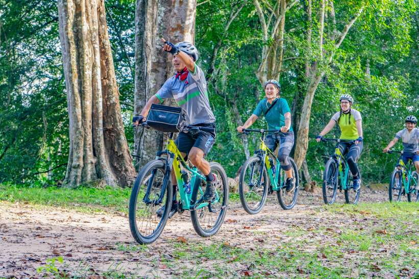 Siem Reap: Angkor Sunset Bike & Boat Tour /E-Bike Available - How the guide frames Angkor as you ride, not just as you watch
